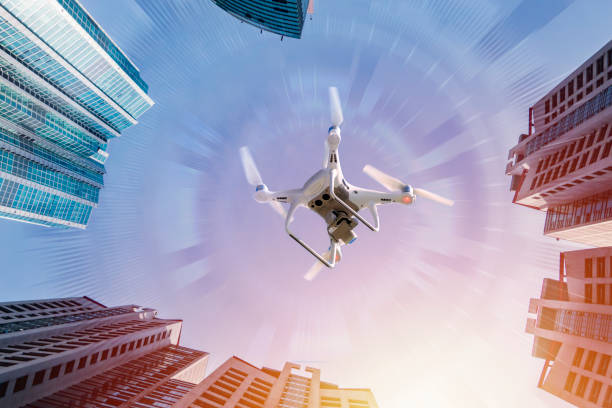Drone Drone production that flies between buildings. multicopter stock pictures, royalty-free photos & images