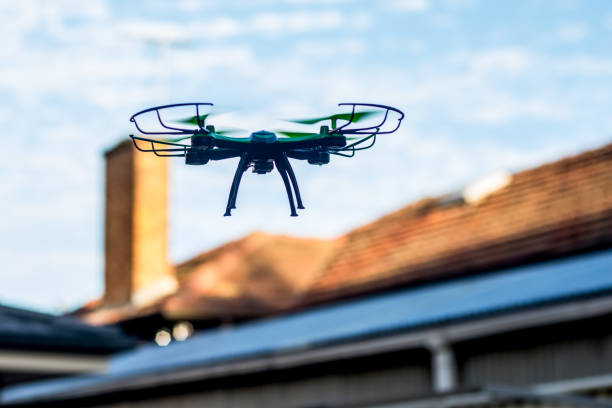 Drone quad copter flying over the roofs. Drone photography and videography. Toy drone. Copy space Drone quad copter flying over the roofs. Drone photography and videography. Toy drone flight. Copy space drone point of view stock pictures, royalty-free photos & images