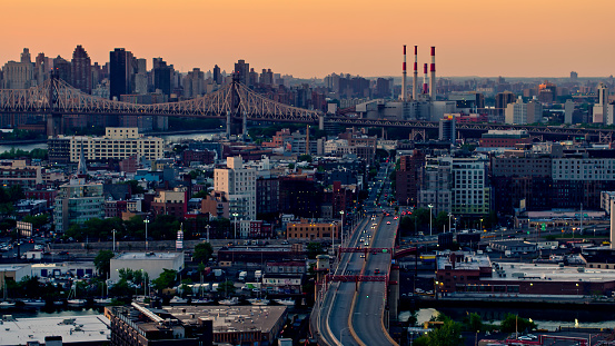 Drone shot of New York City at sunset, taken from over Greenpoint in Brooklyn and looking towards Queens with Manhattan beyond.