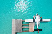 istock Drone view of seaplane docked at hotel pier 1310717554