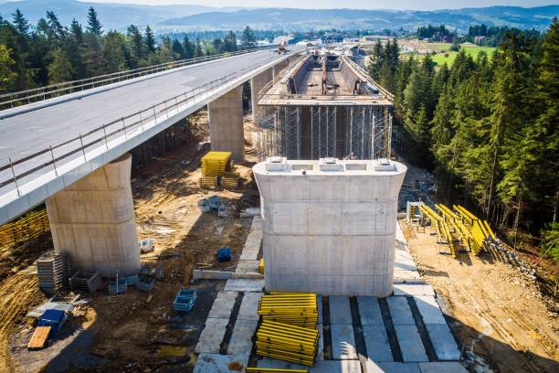 Drone view on highway bridge in construction Aerial drone view on highway bridge in construction road construction stock pictures, royalty-free photos & images