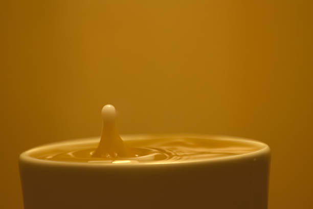 Drop of Creamer in Coffee stock photo