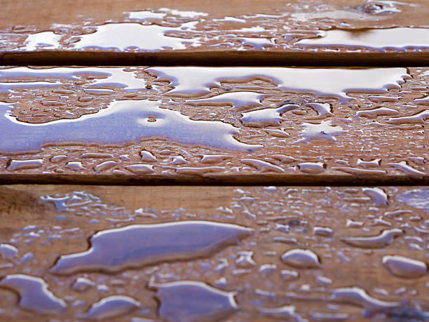 Droplets of water on a wooden deck stock photo