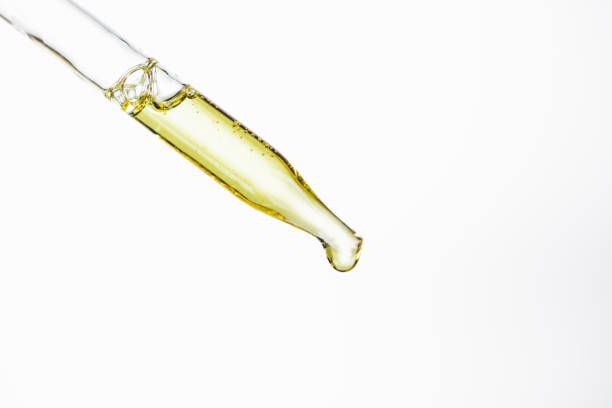 dropper and drop of natural serum isolated on white dropper and drop of natural serum isolated on white pipette stock pictures, royalty-free photos & images