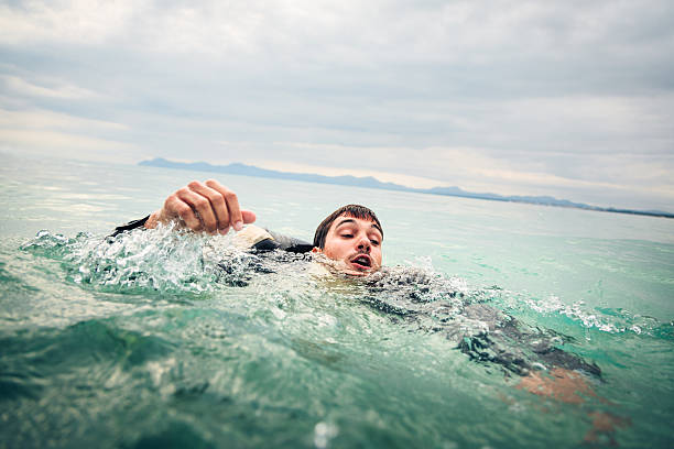 drowning businessman stock photo