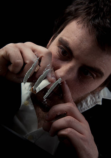 Drug Addict A drug addict sniffing cocaine snorting stock pictures, royalty-free photos & images