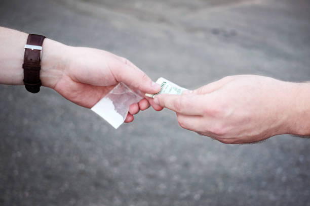 Drug selling concept. Close up hands, trading meth. stock photo