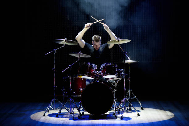 Drummer playing the drums with smoke and powder in the background. stock photo