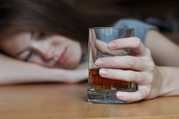 Drunk female addict Drunk female with a glass of whiskey alcohol abuse stock pictures, royalty-free photos & images