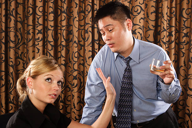 Drunk man comes on to a woman stock photo