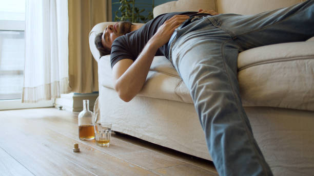 drunk-man-sleeping-on-the-couch-picture-id1225158171