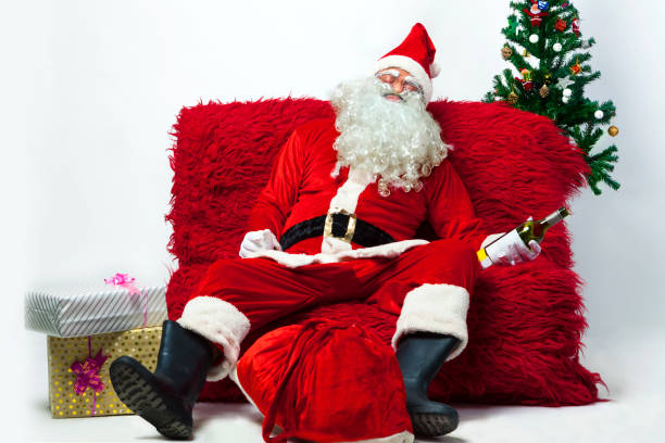 drunk-santa-claus-lying-on-sofa-picture-id886499846