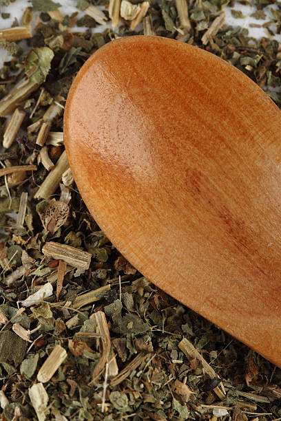 Dry basil with a wooden spoon stock photo