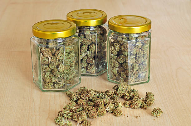 Dry cannabis buds stored in glass jars stock photo