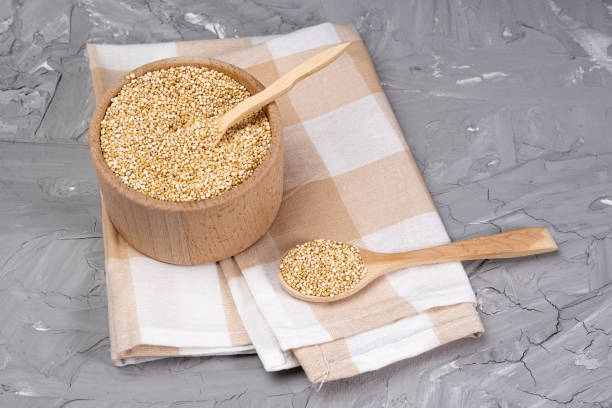 dry quinoa cereal bowls on grey concrete background table. Gluten free cereals stock photo