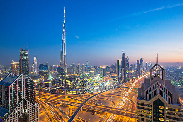 Dubai skyline High up view of Dubai and its roads at dusk. burj khalifa stock pictures, royalty-free photos & images