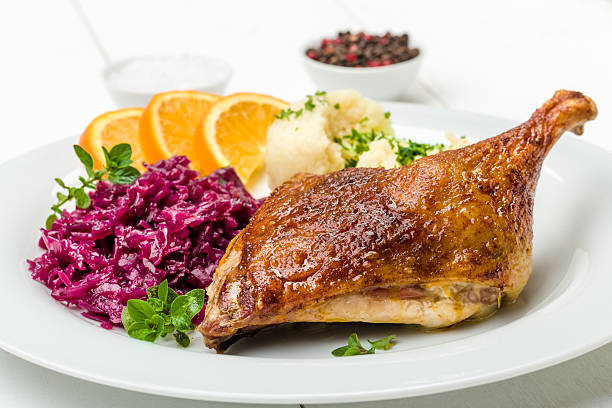 Duck with dumplings and red cabbage Roast duck with dumplings, red cabbage and oranges goose meat photos stock pictures, royalty-free photos & images
