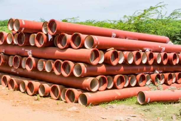 ductile iron pipes stocked in open space of a rural village store yard. stock photo