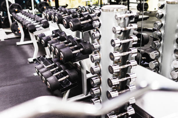 Dumbbells on stand in gym stock photo