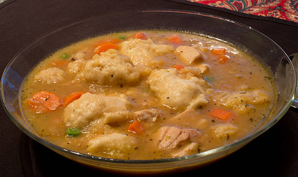 Dumpling Stew A hearty dumpling stew with chicken, dumplings, carrots, and peas. chicken dumplings stock pictures, royalty-free photos & images