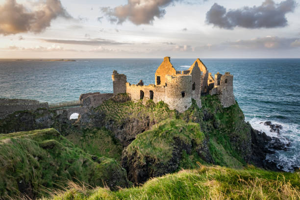 Dunluce Castle This is a picture of the ruins of Dunluce Castle in Northern Ireland.  It was built in the 13th century on the top of a sea cliff looking out to the Atlantic Ocean northern ireland stock pictures, royalty-free photos & images