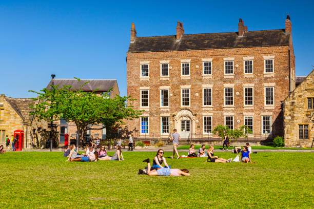 Durham City Palace Green Students 25 May 2017: Durham City, England, UK - students and tourists enjoying the sunshine on Palace Green. durham stock pictures, royalty-free photos & images