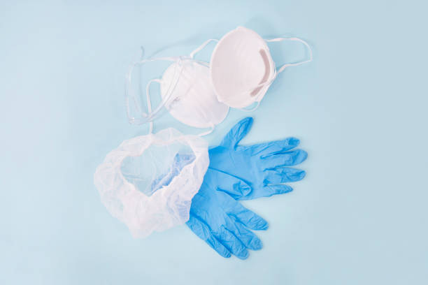 dust mask, blue gloves and head cover stock photo