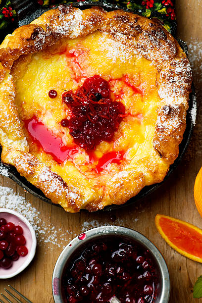 Dutch Baby with Cranberry Orange Compote Dutch Baby with Cranberry Orange Compote dutch culture stock pictures, royalty-free photos & images