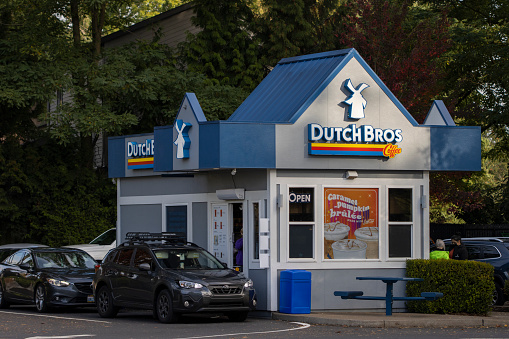 Tigard, OR, USA - Oct 11, 2021: Cars line up at a Dutch Bros Coffee shop in Tigard, Oregon. Dutch Bros. Coffee is an American drive-through coffee chain headquartered in Grants Pass, Oregon.