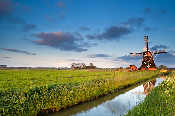Dutch windmill at sunrise charming Dutch windmill at sunrise, Groningen, Netherlands groningen city stock pictures, royalty-free photos & images
