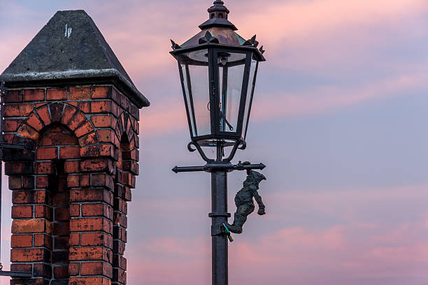 Dwarf on a lamp Dwarf on a lamp post on bridge in Wroclaw, Poland. Sunrise. wroclaw stock pictures, royalty-free photos & images
