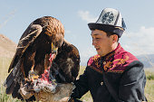 istock Eagle Hunter in traditional costume with Eagle after hunting in the mountains of Central Asia 1343808604