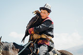 istock Eagle Hunter in traditional costume with Eagle in the mountains of Central Asia 1343808668