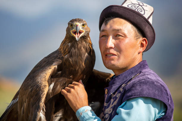Eagle Hunter, Issyk Kul, Kyrgyzstan Issyk Kul, Kyrgyzstan - September 1, 2019: Eagle hunter and his Golden Eagle in Issyk Kul, Kyrgyzstan tien shan mountains stock pictures, royalty-free photos & images