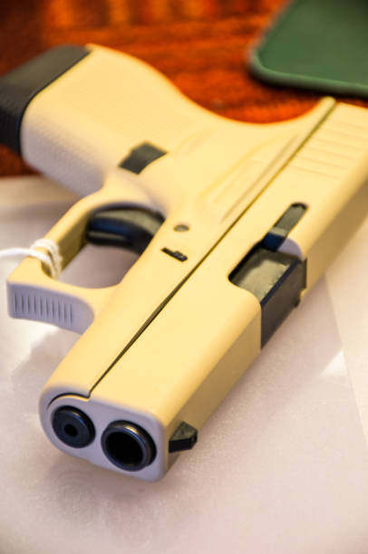 Easily buying a Pistol at a Gun store in Texas after another school shooting Pistol laying on Counter at a Gun store in Texas after another school shooting texas school shooting stock pictures, royalty-free photos & images