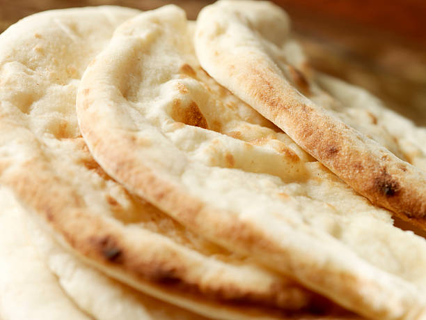 East Indian Naan Bread East Indian Naan Bread -Photographed on Hasselblad H1-22mb Camera naan bread stock pictures, royalty-free photos & images