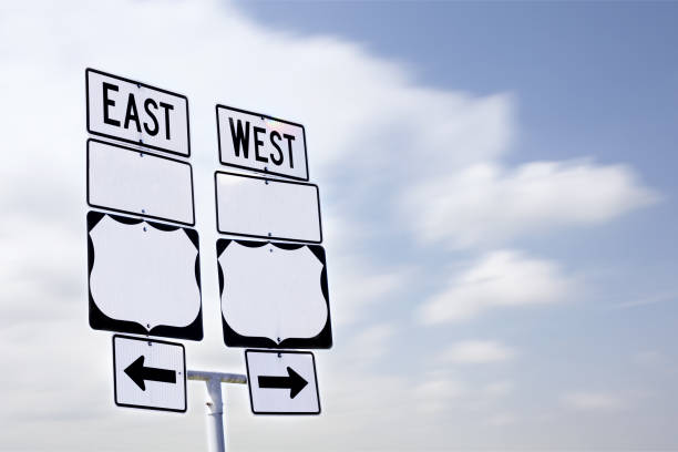 East West Sign with Arrows stock photo
