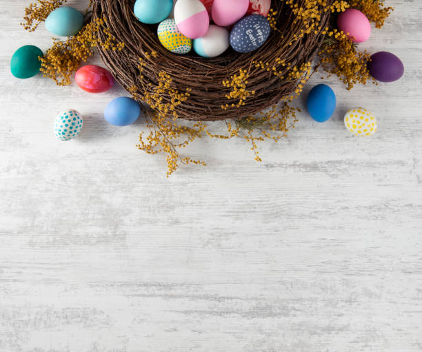 Easter Background Easter wreath background with colored eggs easter stock pictures, royalty-free photos & images