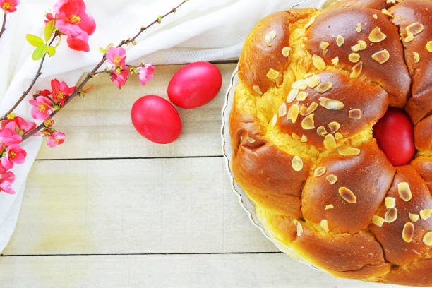 Easter bread, Easter eggs and a branch of flowering quince Easter bread, Easter eggs and a branch of flowering quince on wooden table orthodox church stock pictures, royalty-free photos & images