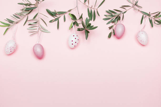 Easter Composition with Olive Branch and Easter Decoration on Pastel Pink Background  easter sunday stock pictures, royalty-free photos & images