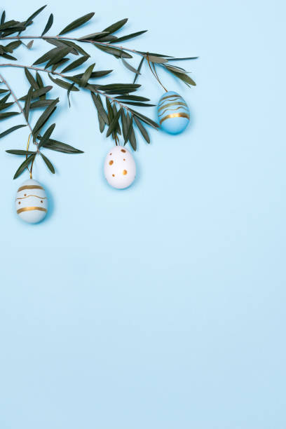 Easter Composition with Olive Branch and Easter Decoration on Pastel Blue Background  easter sunday stock pictures, royalty-free photos & images