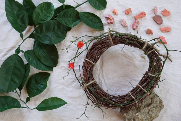 Easter consept with Crown of Thorns and green twig of tree, stone  on  white cloth background  good friday stock pictures, royalty-free photos & images