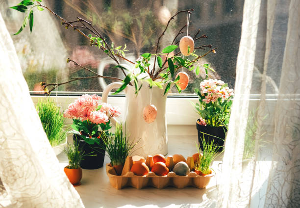 Easter decor. Windowsill with pink Easter eggs. stock photo