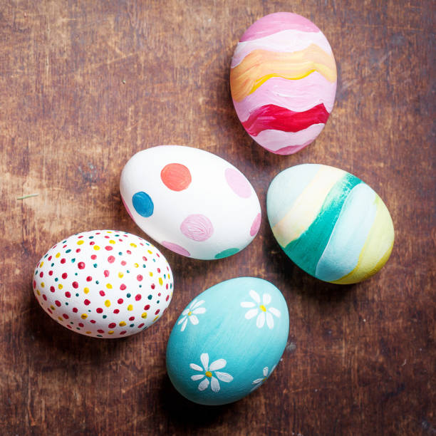 Easter eggs in nest on rustic wooden planks with copyspace. Happy...