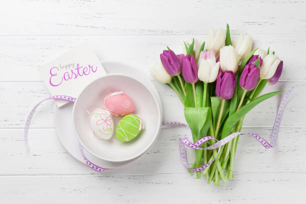 Easter greeting card with tulip flowers bouquet and easter eggs. Top...