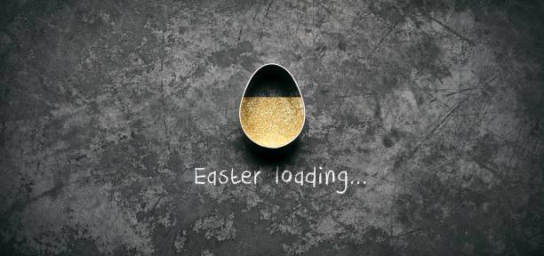 Easter loading concept. Egg shaped pastry cutter and golden glitter on old metal  easter sunday stock pictures, royalty-free photos & images