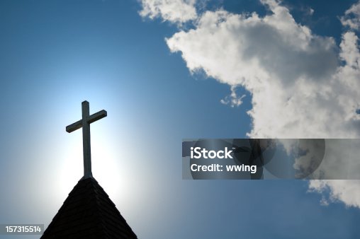 istock Easter morning with the sun behind a church steepl cross. 157315514