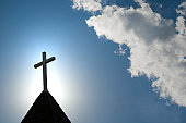 istock Easter morning with the sun behind a church steepl cross. 157315514
