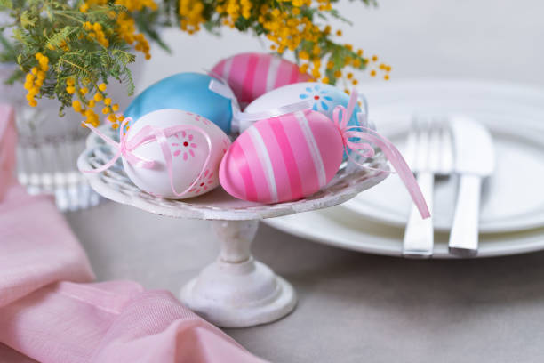 Easter table setting with mimoza flowers and cutlery. Holidays background stock photo