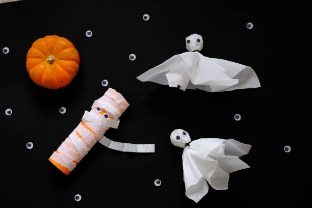 Easy DIY Halloween crafts for kids. Paper ghosts. stock photo